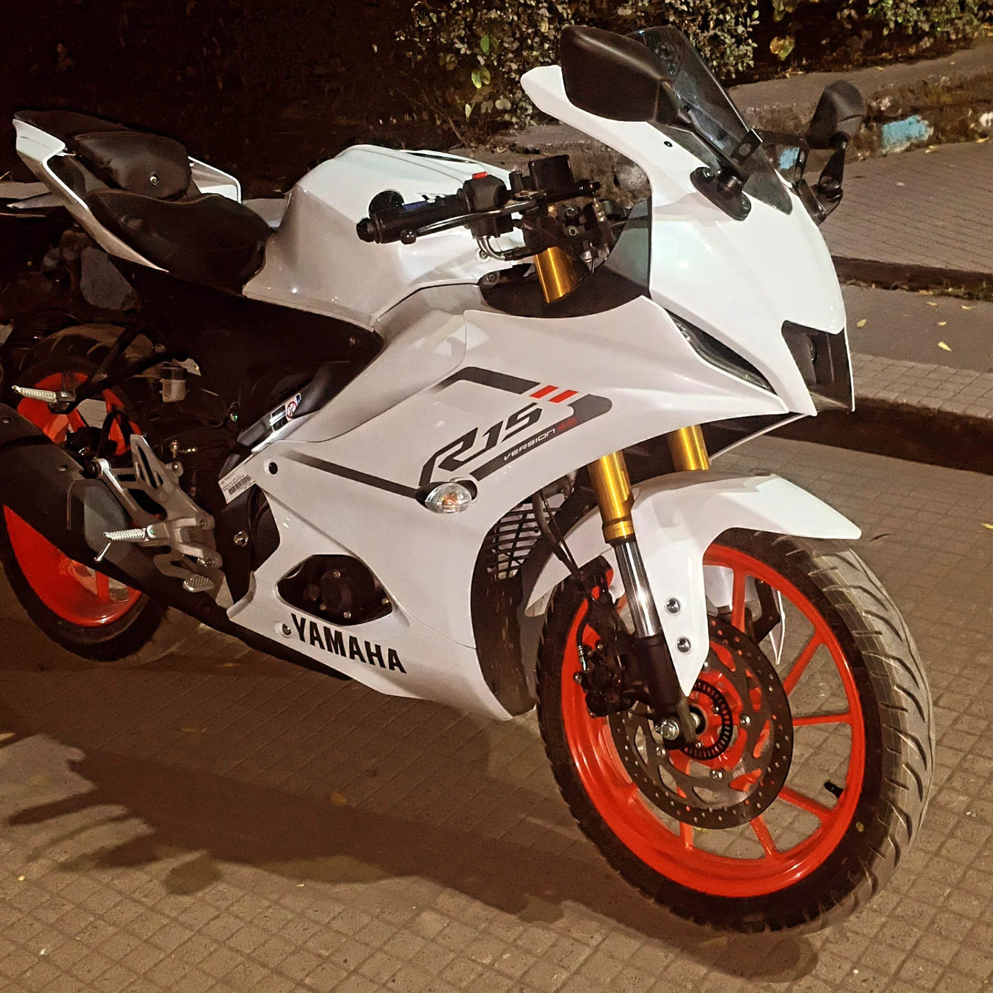 White Yamaha motorcycle with red wheels